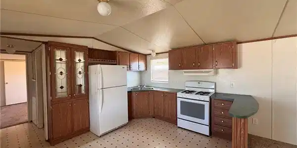 Image 3: This manufactured home offers a spacious lot with