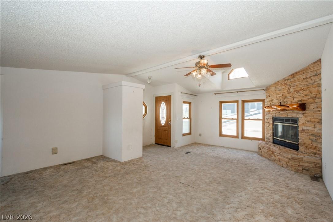 Image 4: A cozy living space features a stone fireplace, sk