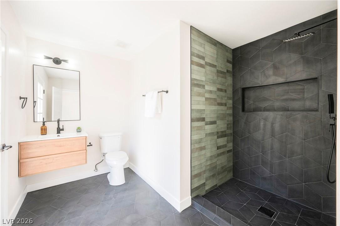 Image 2: A well-appointed bathroom features a sleek vanity,