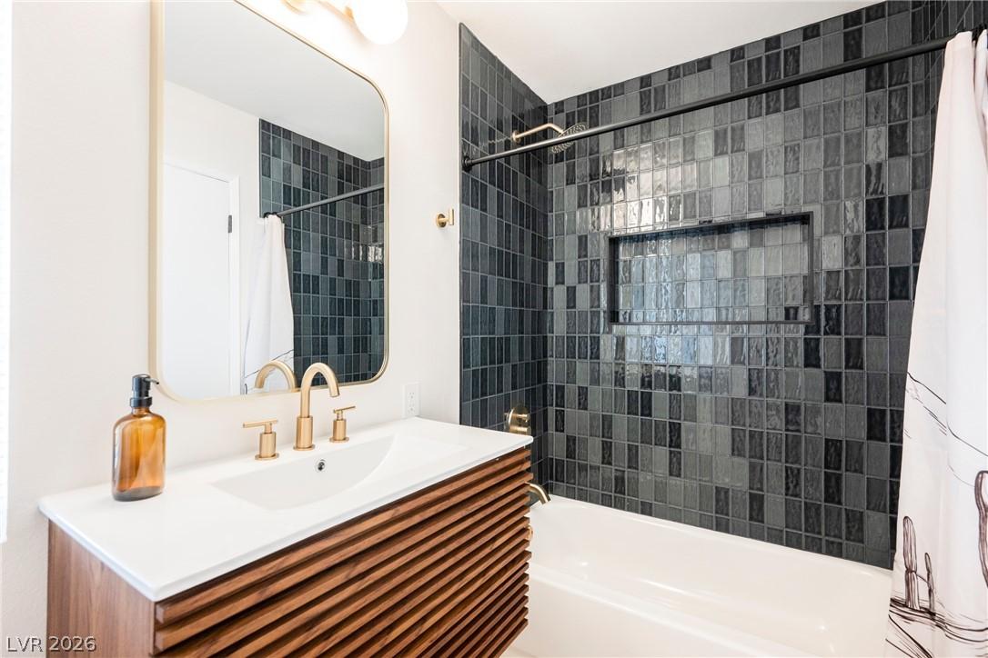 Image 3: A well-appointed bathroom offers sleek vanity, war