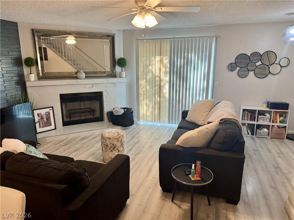 Image 3: Living area with ceiling fan, a textured ceiling,
