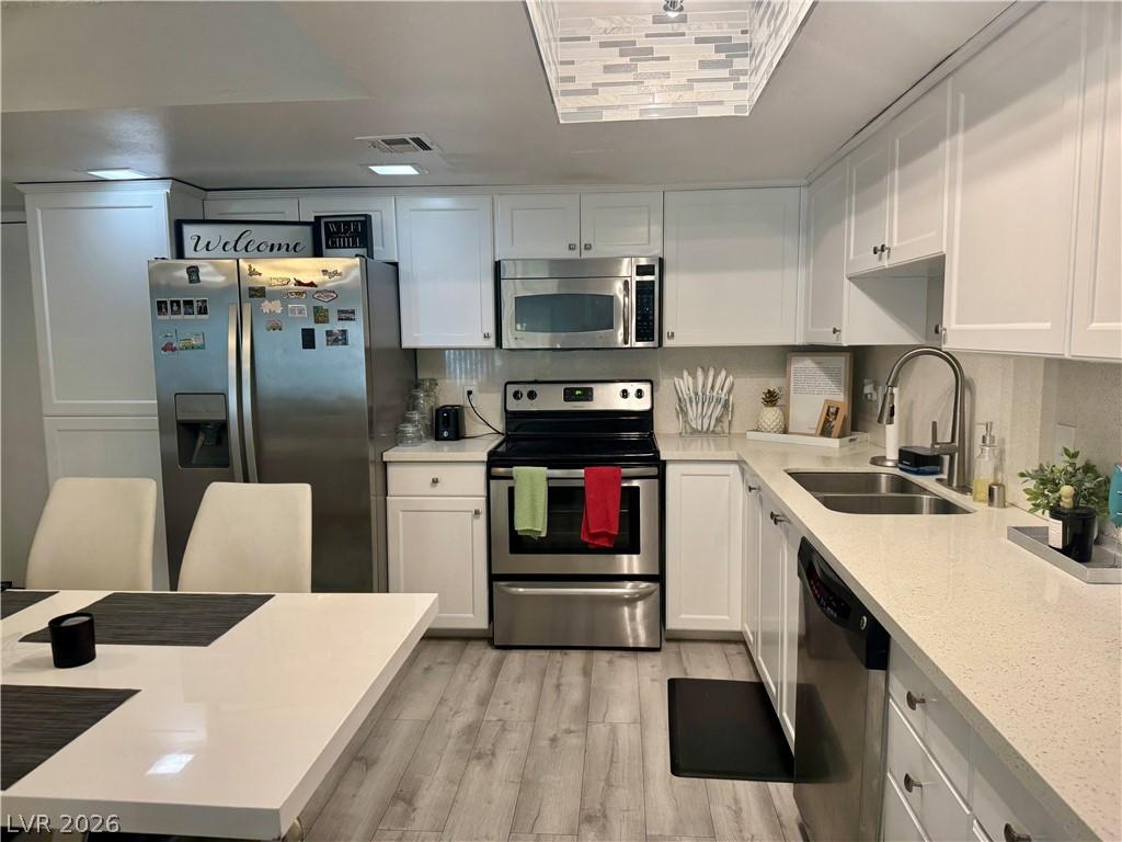 Image 4: Kitchen with stainless steel appliances, a sink, l