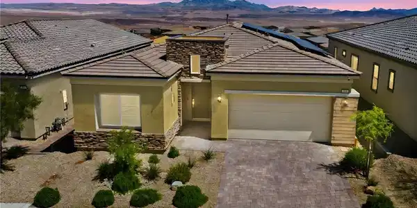 Image 2: A desert oasis with solar panels atop, this home o
