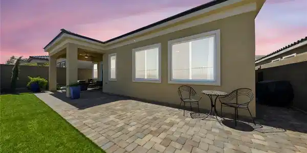 Image 4: An inviting backyard oasis features a paved patio