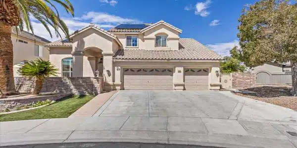 Image 3: A spacious driveway leads to this classic two-stor