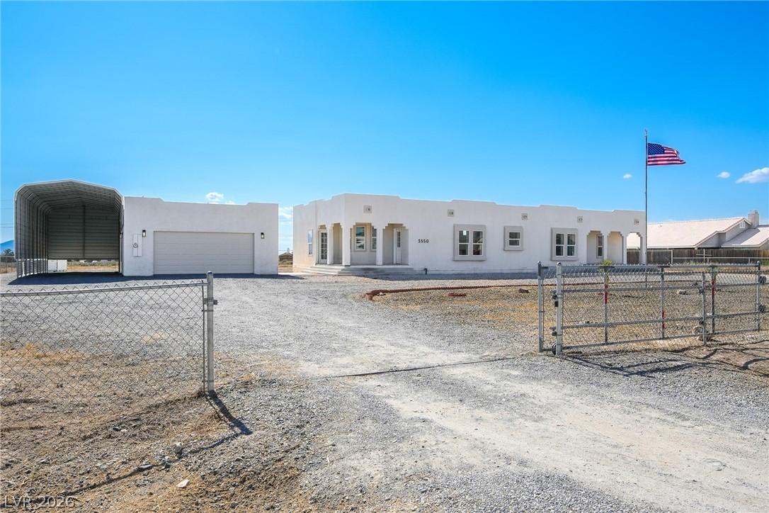 Image 1: Gravel driveway leads to this single-story home fe