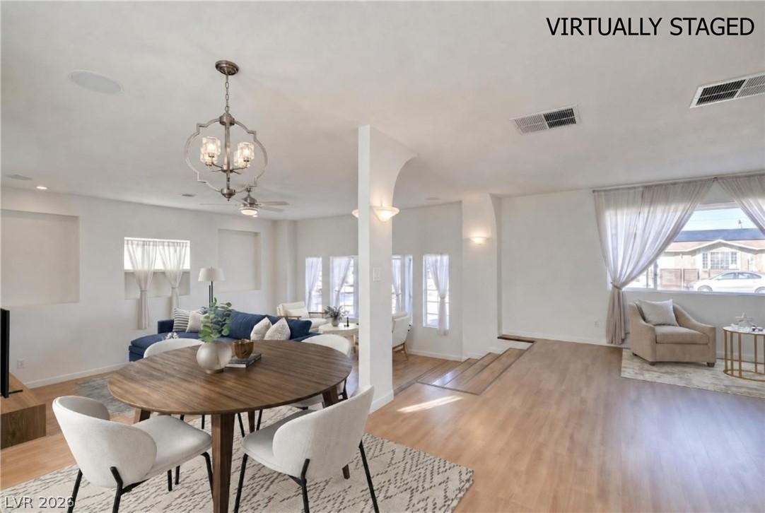 Image 3: An open floorplan seamlessly connects dining and l