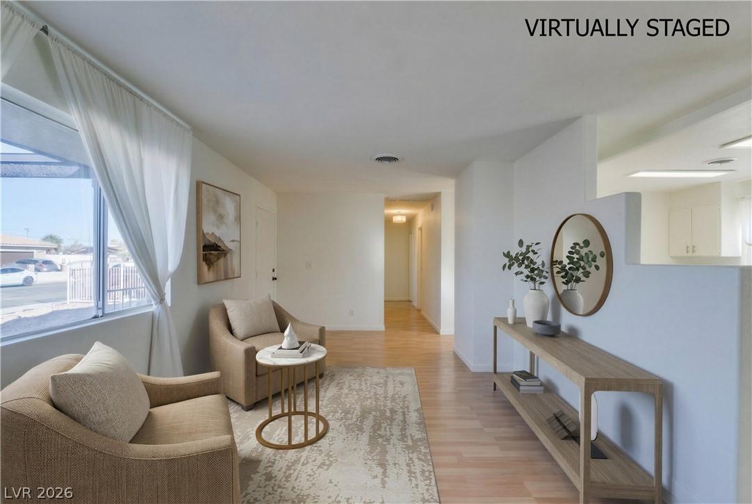 Image 4: Luminous living space featuring polished hardwood