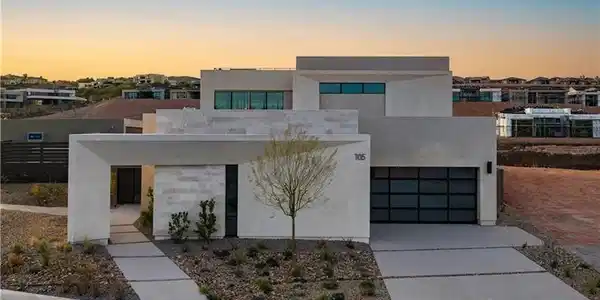 Image 2: Contemporary house with stucco siding, driveway, a