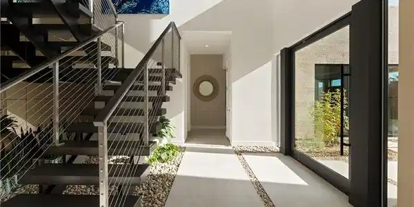 Image 4: Stairs featuring inlaid floor details, a high ceil