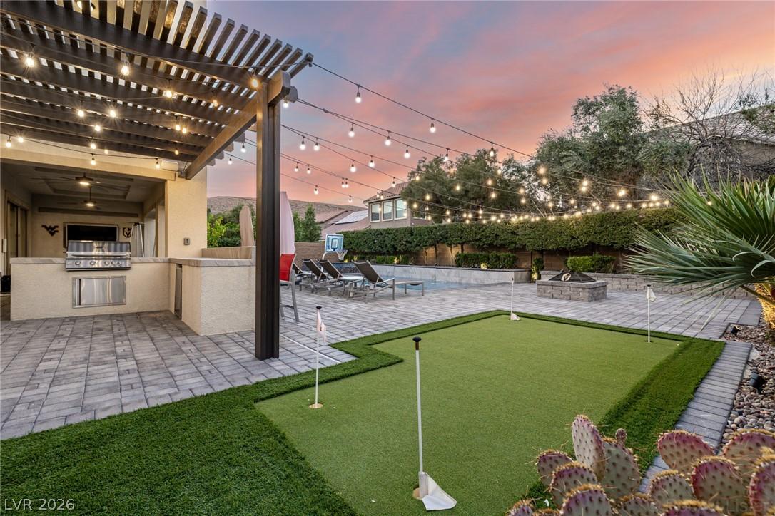 Image 4: An entertainer's dream, this backyard features a b