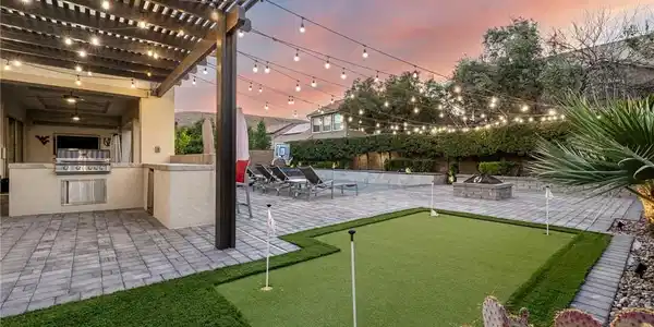 Image 4: An entertainer's dream, this backyard features a b