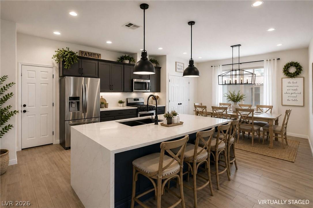 Image 3: A generously sized kitchen island with seating anc