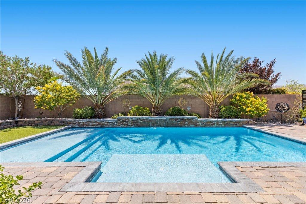 Image 4: A private backyard oasis awaits with a sparkling p