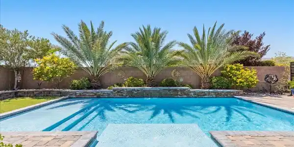Image 4: A private backyard oasis awaits with a sparkling p