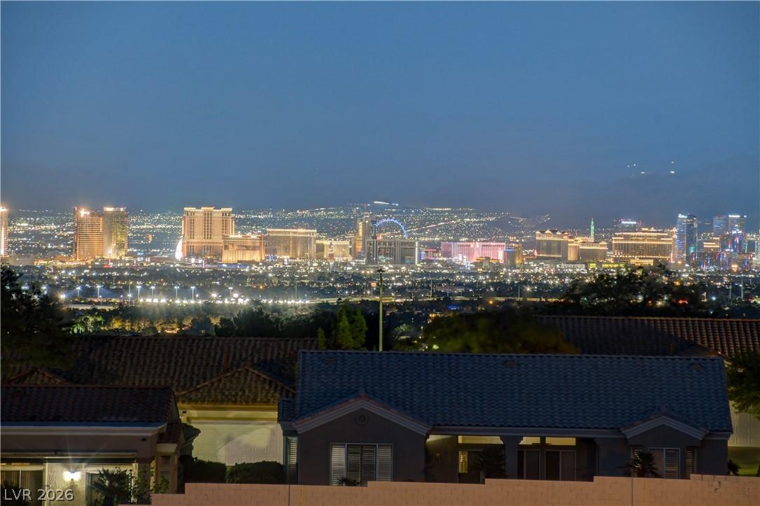 Image 3: City lights glimmer across the horizon, offering a