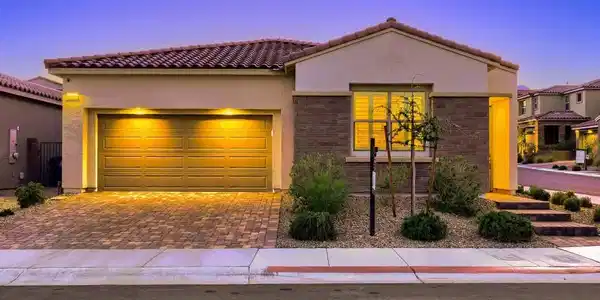 Image 3: Warm exterior lighting illuminates a modern single