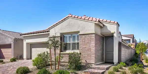 Image 4: Clean lines and a mixture of stone and stucco defi