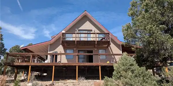 Image 2: Rear view of property with a deck