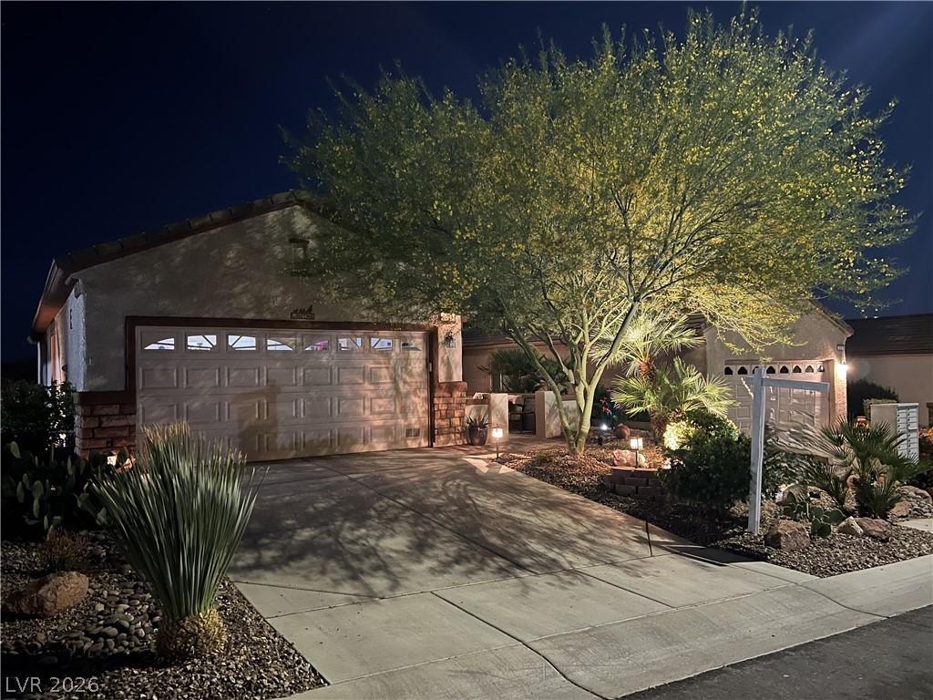 Image 1: Illuminated desert landscaping frames this welcomi