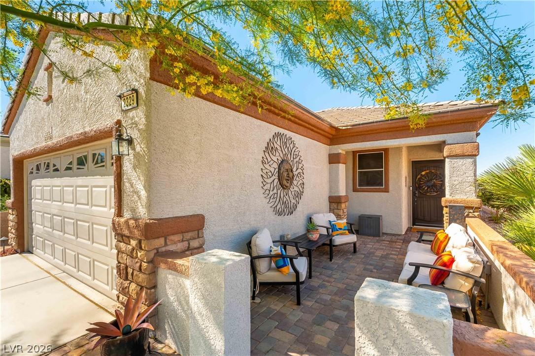 Image 3: A welcoming paver patio leads to the front entry o