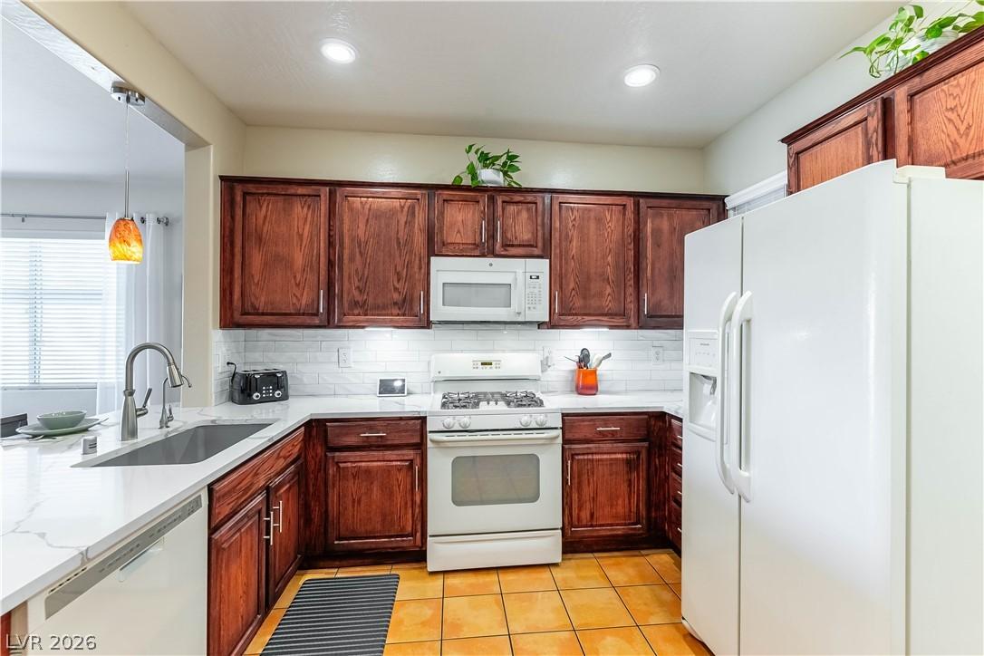 Image 4: A well-appointed culinary space featuring rich woo