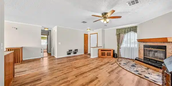 Image 4: A welcoming living area featuring rich hardwood fl