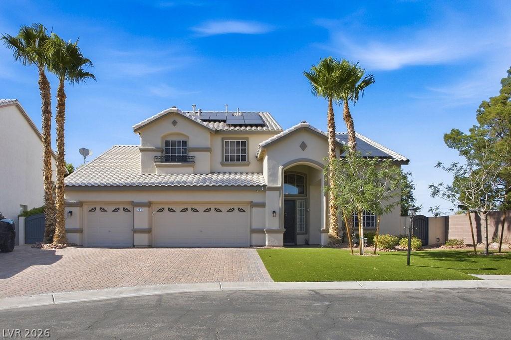 Image 2: An inviting facade showcases a paver driveway, wel