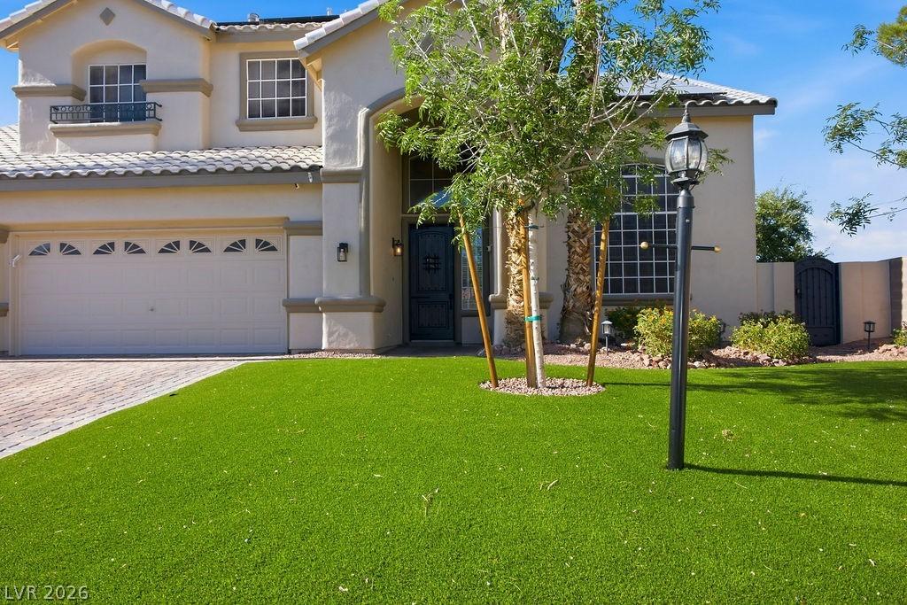 Image 4: A striking stucco home with a tile roof and artifi