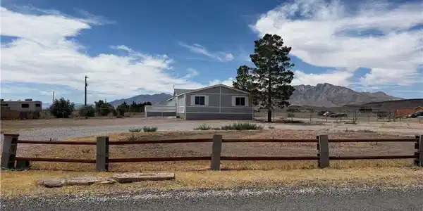 Image 2: A rural setting with mountain views surrounds this