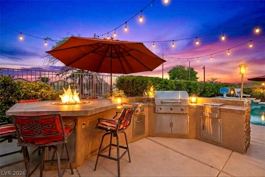 Image 3: An inviting outdoor kitchen and fire pit, perfectl