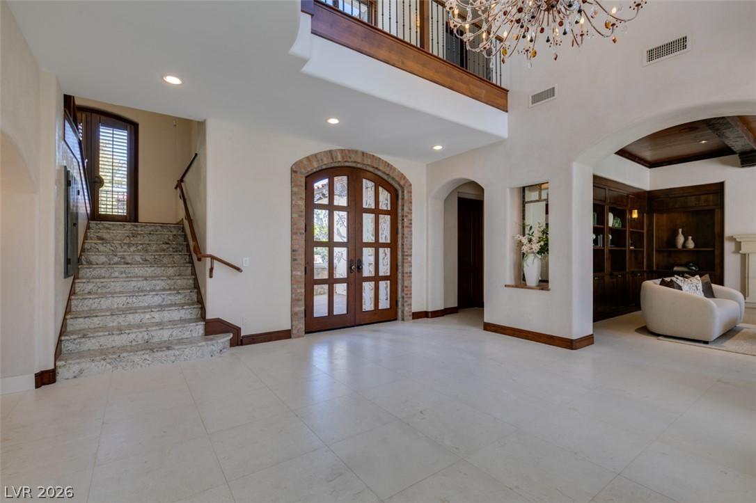 Image 3: Grand entryway with high ceilings, an elegant stai