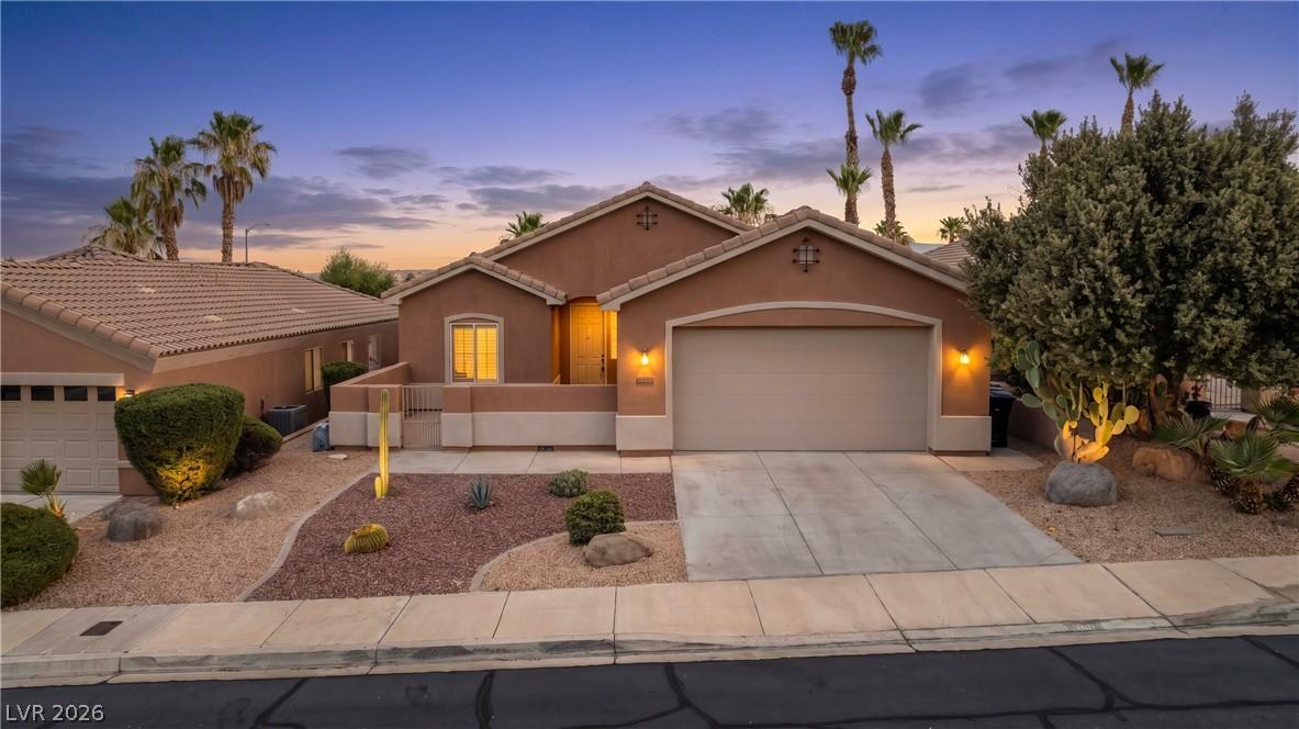 Image 2: An inviting exterior with desert landscaping and a