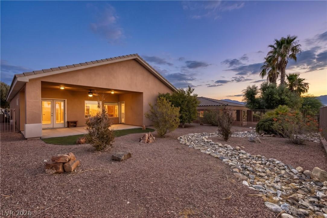 Image 4: A spacious backyard awaits, featuring a covered pa