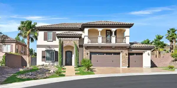Image 2: Front of home with grand entry, stone-accented ext