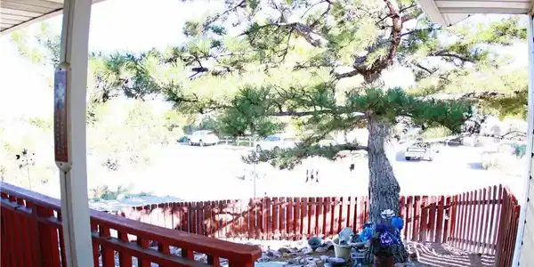 Image 2: A welcoming front porch offers a tranquil setting