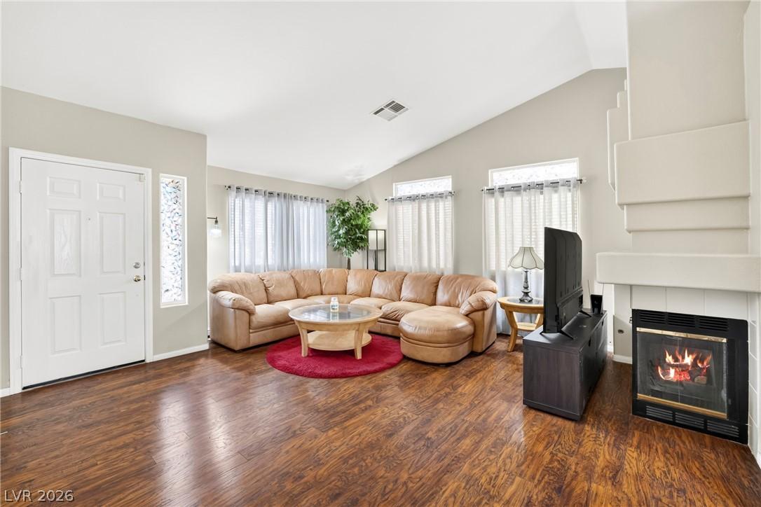Image 3: Cozy living room with a gas fireplace and wood lam