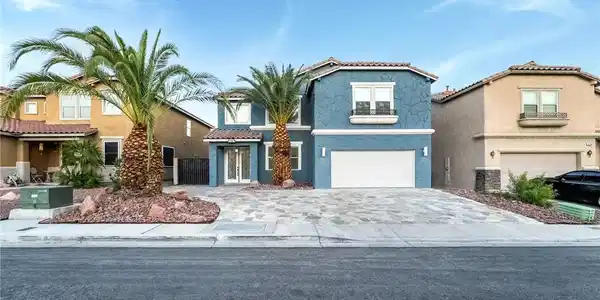 Image 3: Palm trees frame the paved driveway and striking s