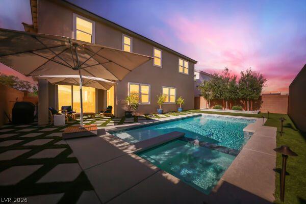Image 4: An inviting backyard oasis features a shimmering p