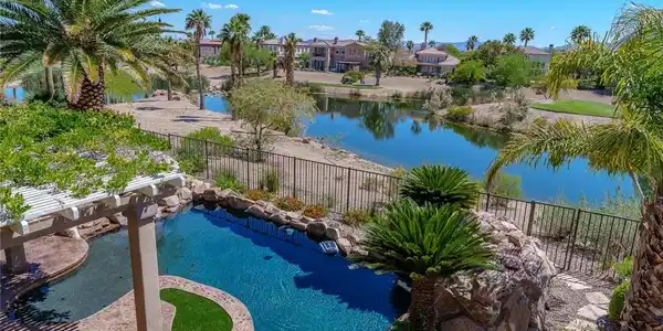 Image 2: View of pool with fence and a water view