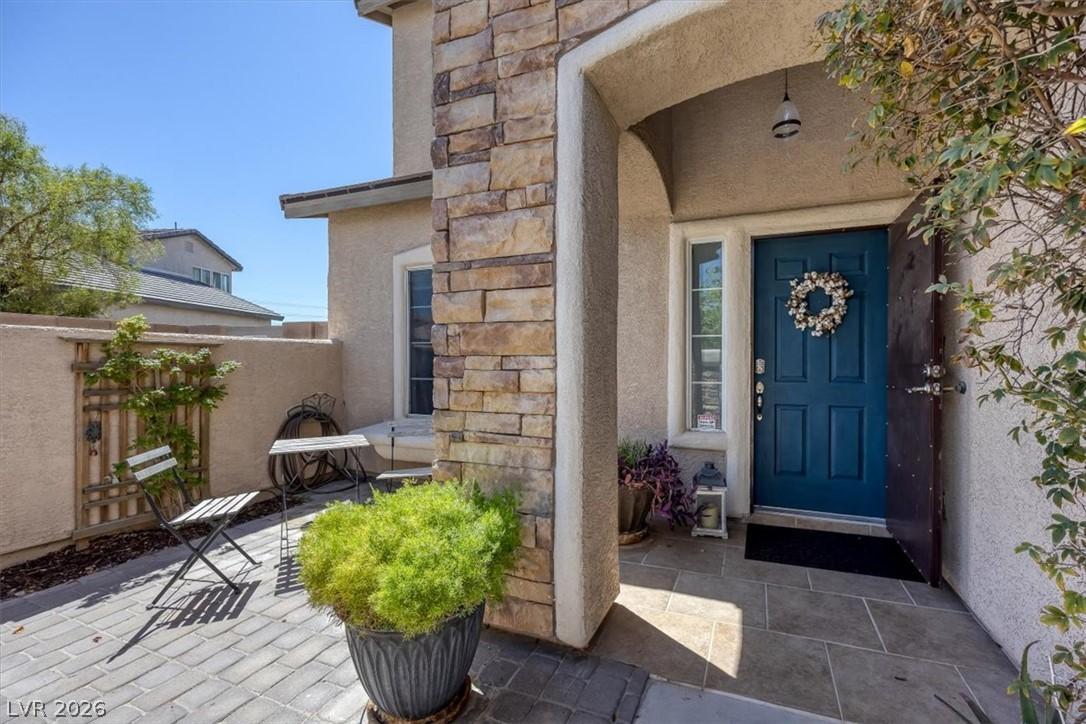 Image 3: A welcoming stone-accented entryway features a vib