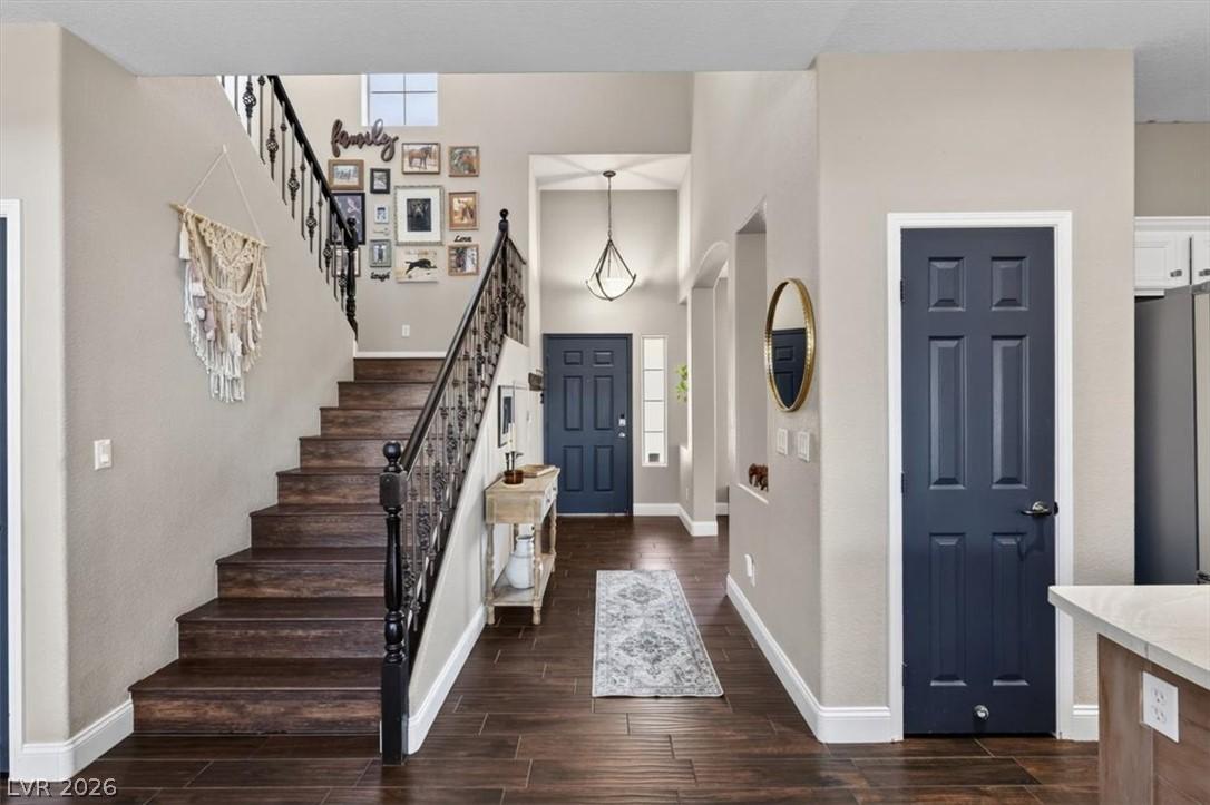 Image 4: Elegant dark wood flooring extends through the ent