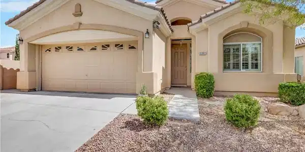 Image 3: Low-maintenance desert landscaping frames the stuc