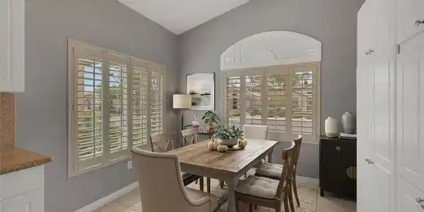 Image 4: Vaulted ceilings and plantation shutters frame thi