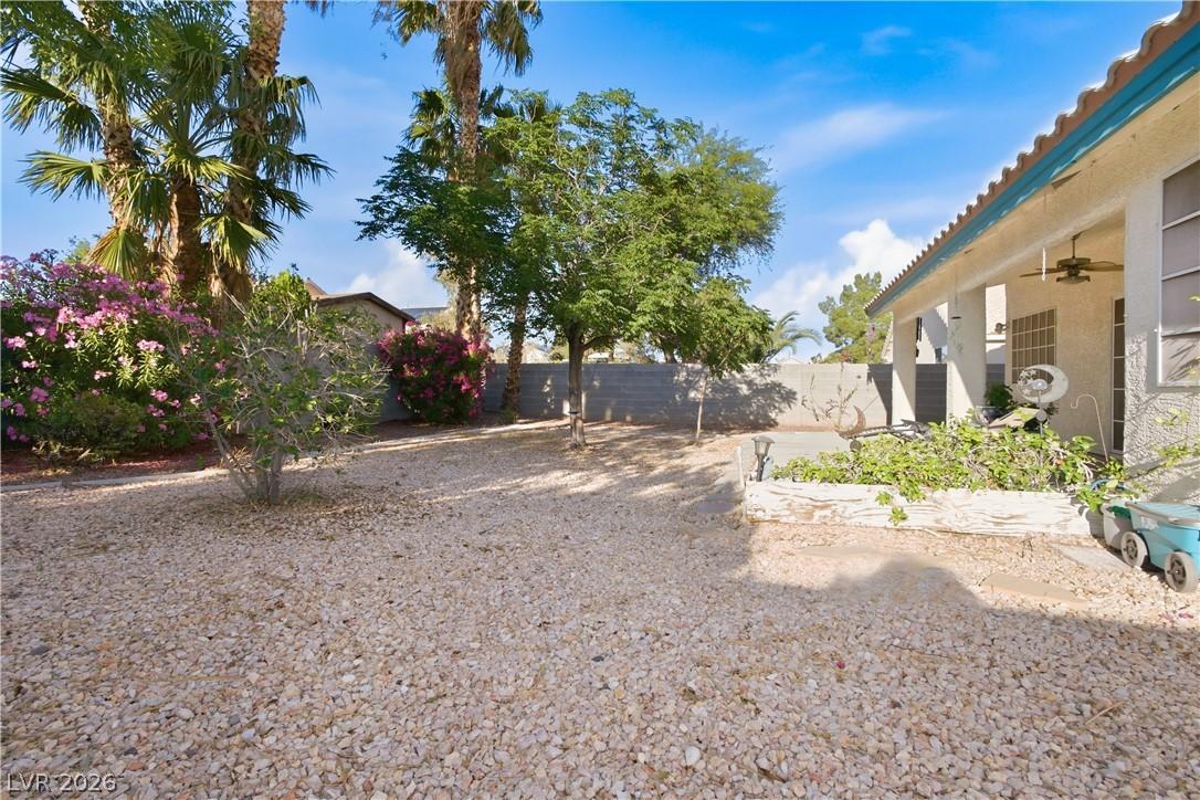 Image 2: This spacious backyard features low-maintenance la