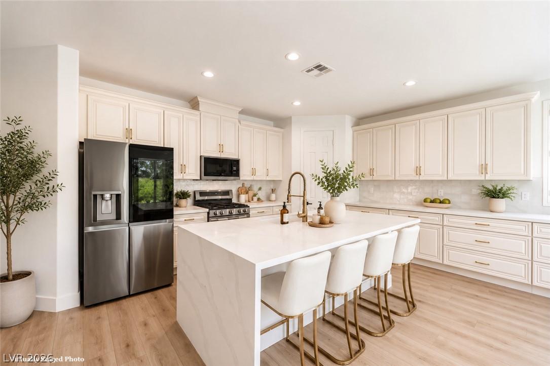 Image 1: A pristine culinary space showcases a grand island
