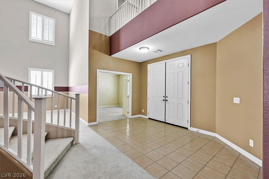 Image 2: A grand two-story entryway greets visitors with ti