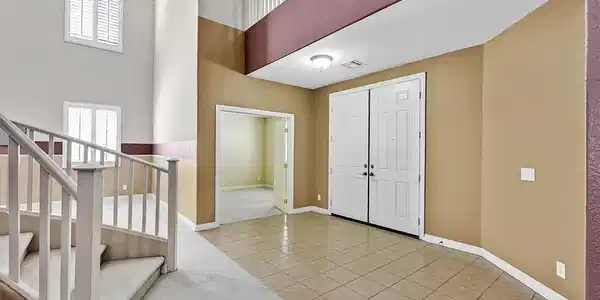 Image 2: A grand two-story entryway greets visitors with ti
