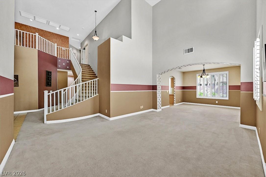 Image 3: A grand entrance with a sweeping staircase and hig