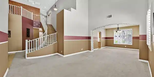 Image 3: A grand entrance with a sweeping staircase and hig